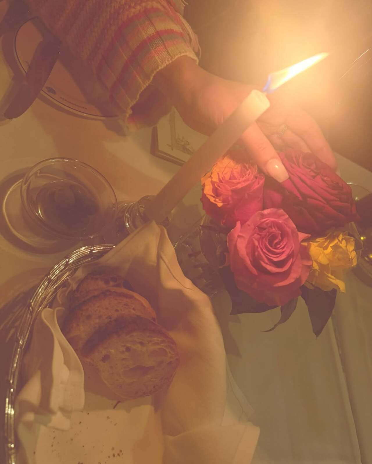 Ranbir Kapoor and Alia Bhatt enjoy a romantic candlelight dinner together, soaking in the intimate evening. Alia is seen admiring the beautiful floral arrangement.