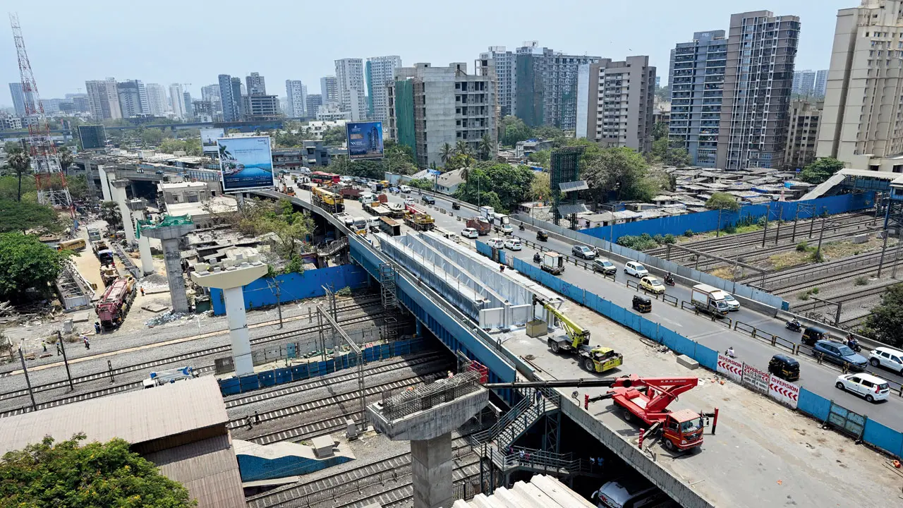 Workers prepare to install steel girders on Metro Line 6 pillars near Jogeshwari railway station on Saturday. Pics/Satej Shinde
