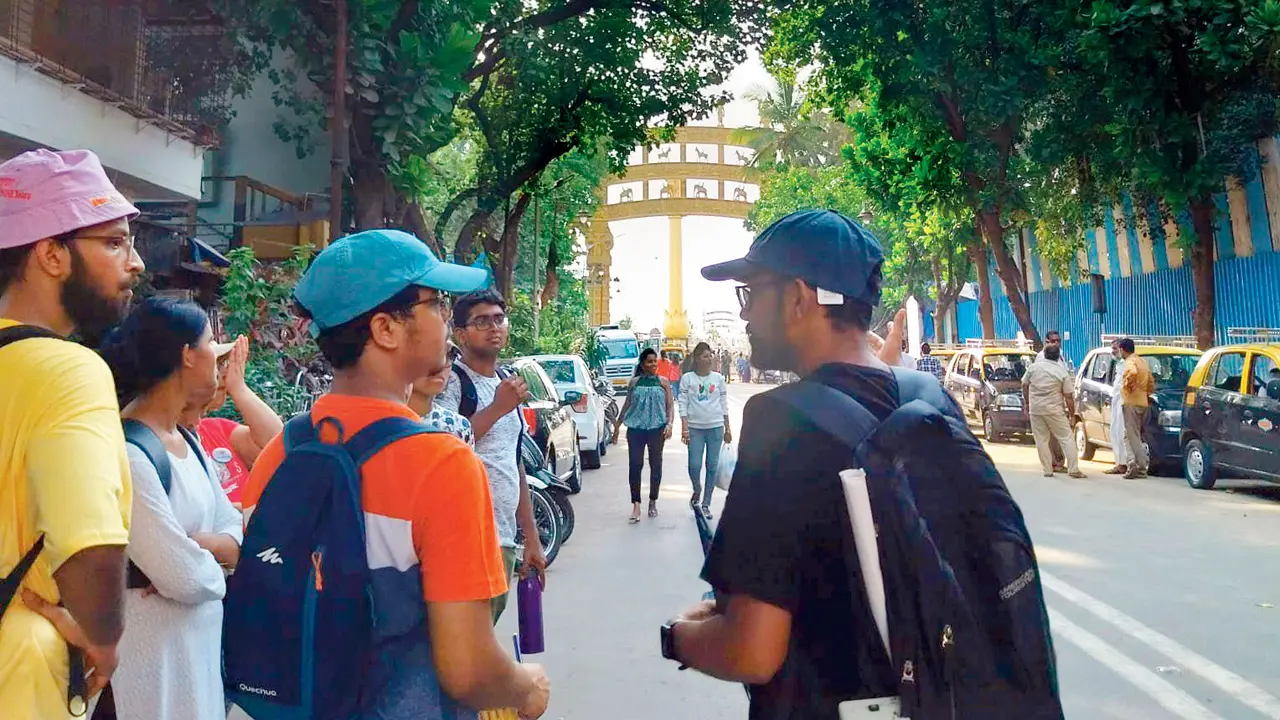 Participants discuss observations during a walk in Dadar