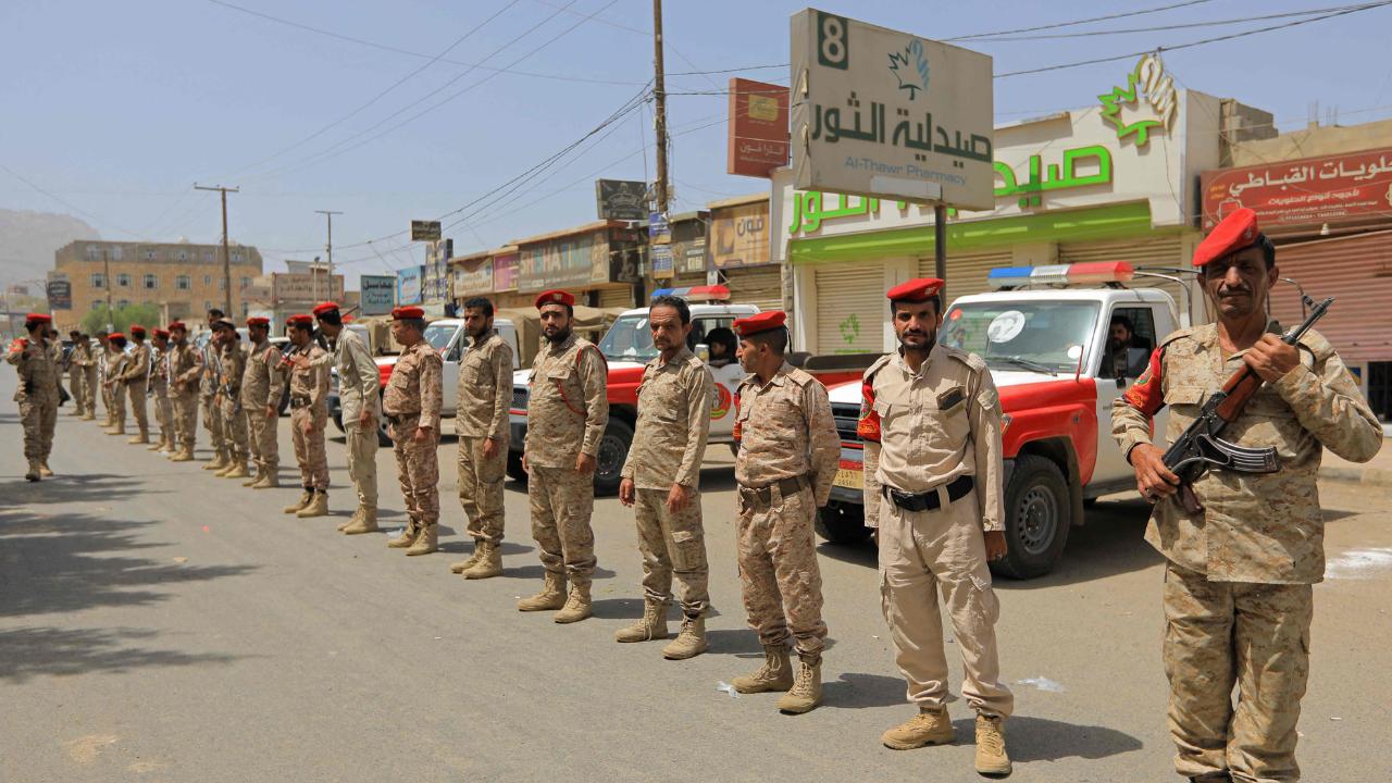 Security forces monitor the scene as hundreds of Houthi supporters gather in Sanaa to express outrage over the Israeli parliament&rsquo;s decision.