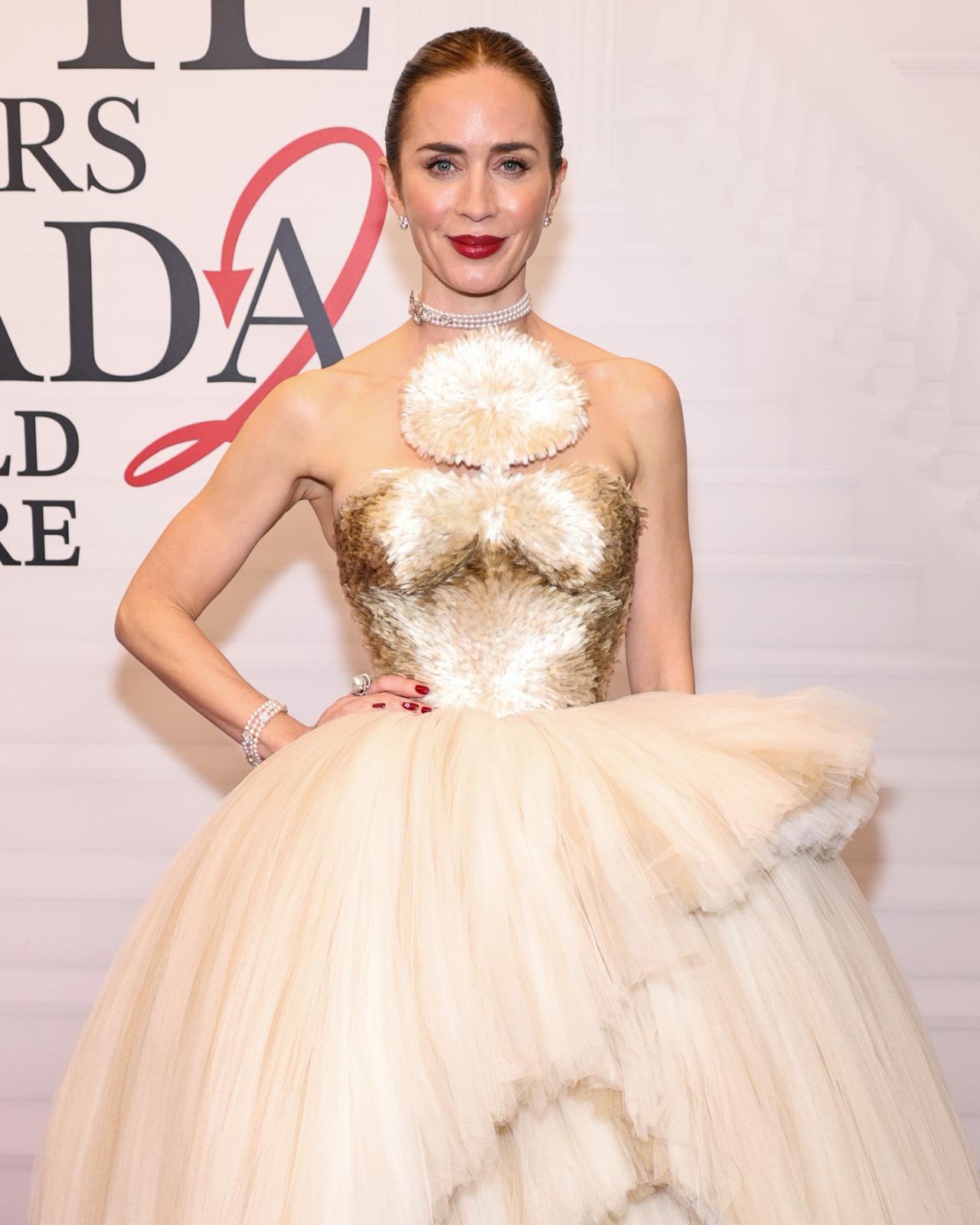 Emily Blunt reprises her role as Emily. While she played Miranda's assistant in the first film, she is now a senior executive at Dior, and is one of Runway's main advertisors