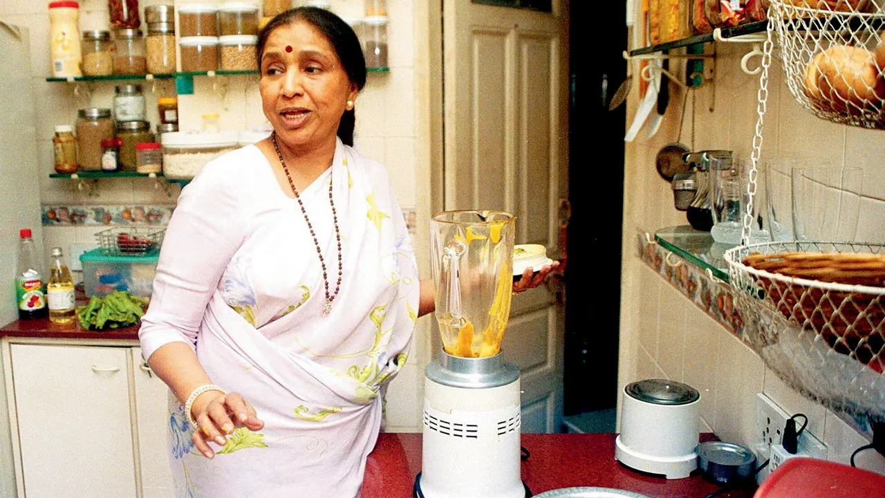 The late Asha Bhosle captured here in the kitchen of her South Mumbai residence, after receiving the Dadasaheb Phalke Award in 2000.  Pic/Rane Ashish