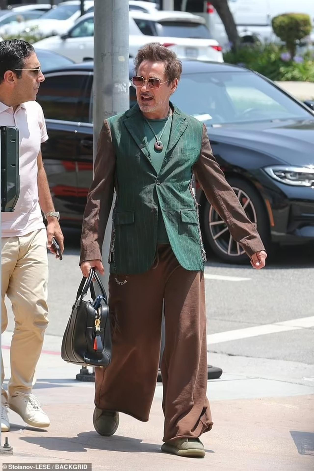 Electric, experimental and stylish, Robert's outfit featured a green striped blazer with brown sleeves paired with matching brown trousers and a necklace.