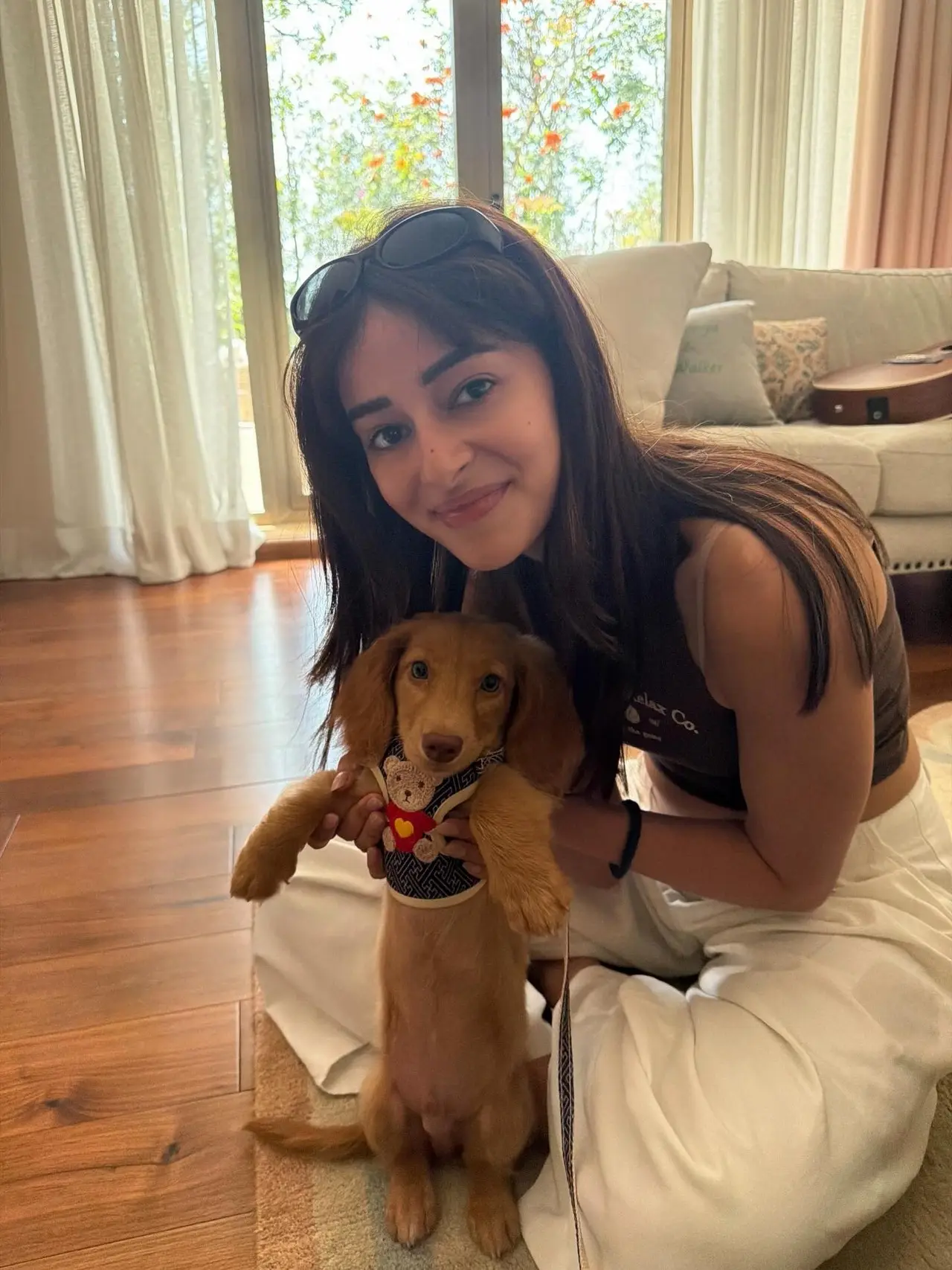 Ananya was seen cuddling with her pet in one of the pictures while comfortably sitting on the floor.