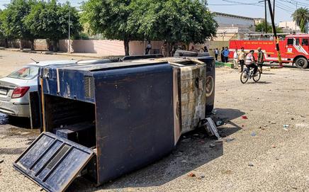 Wreckage of a vehicle is seen during a protest by factory workers demanding a hike in wages, in Noida (Pic/PTI)