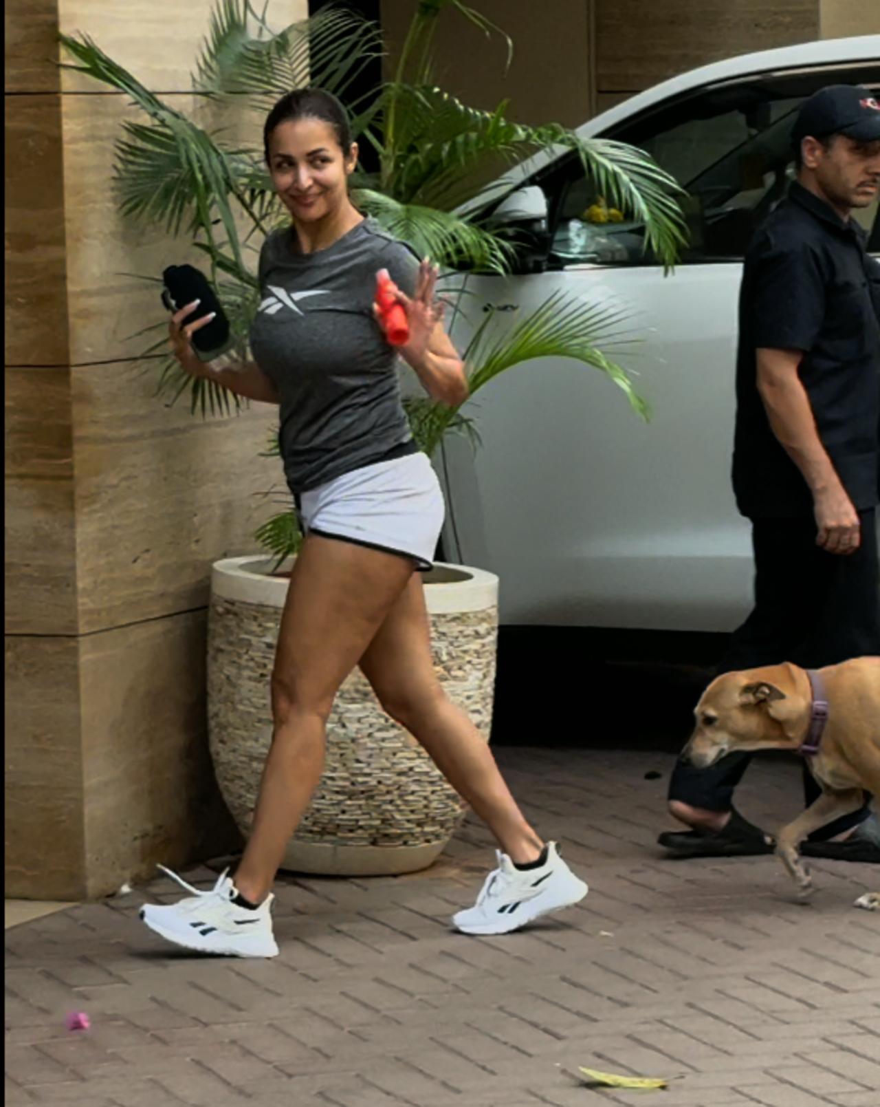 Malaika Arora stepped out for her regular gyming session as she waved at the paps stationed outside.