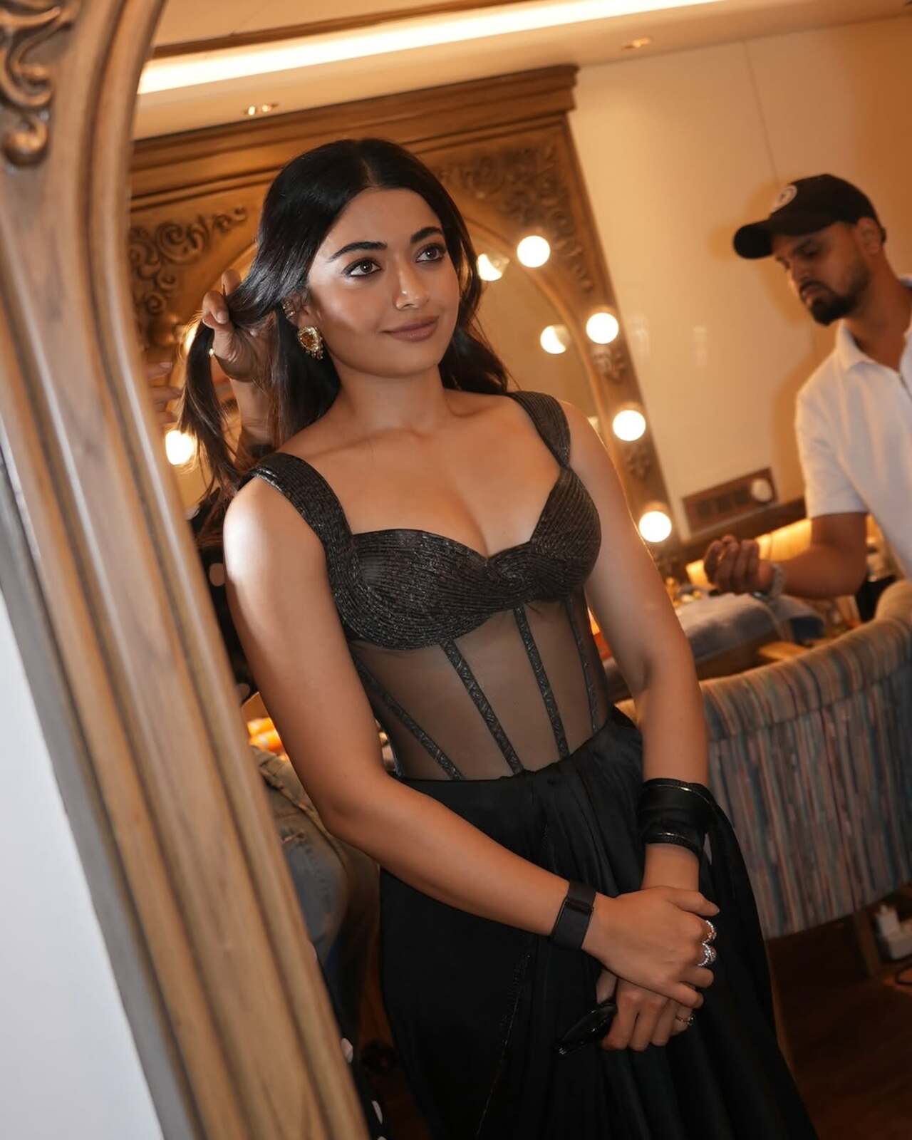 Rashmika stuns in a black gown with a structured corset bodice and sheer paneling, creating a refined, modern statement