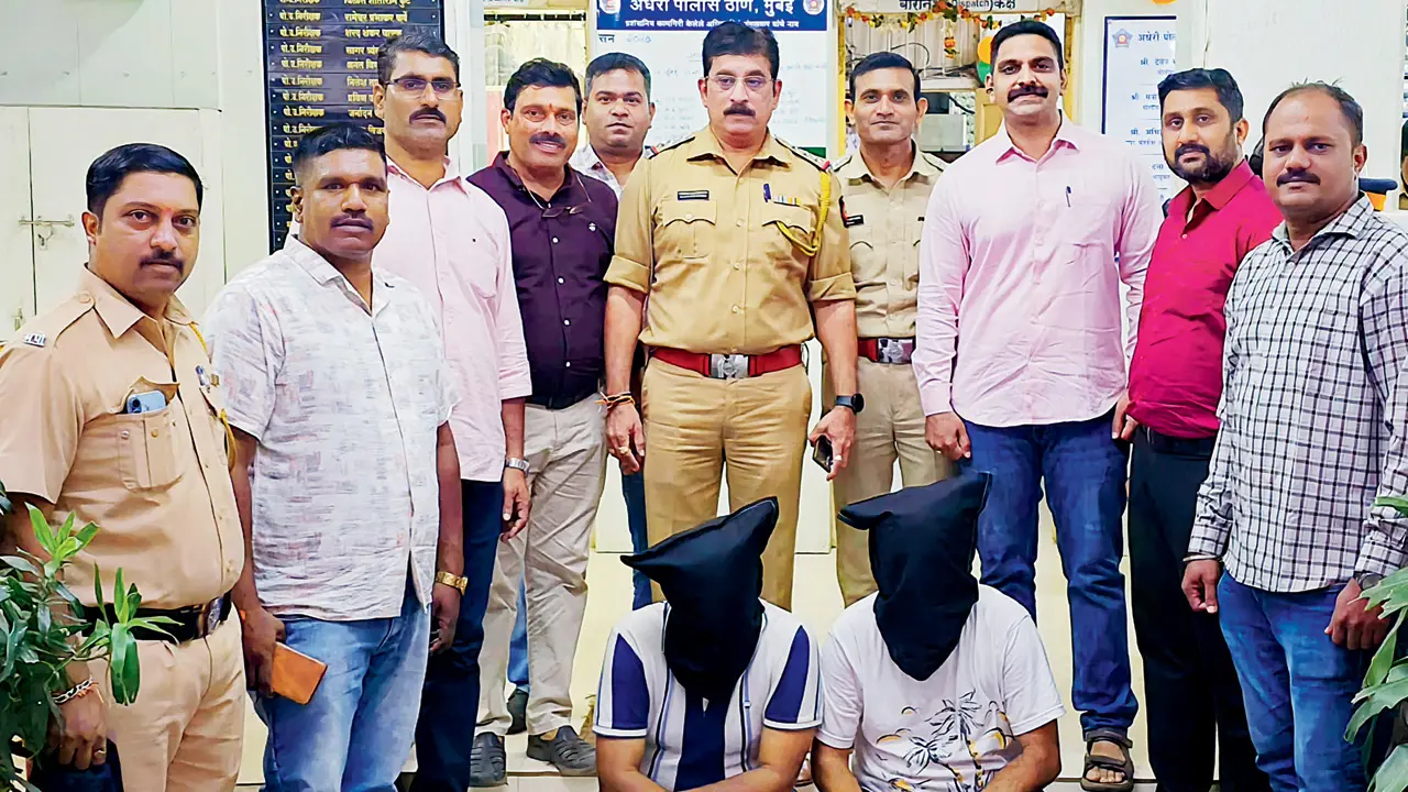 Mumbai police crack Rs 19.78-lakh USDT cheating case, arrest 2 from Mira Road The two accused (masked) in police custody. PICS/BY SPECIAL ARRANGEMENT