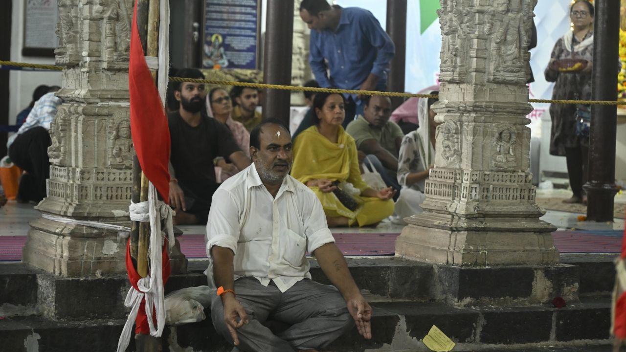 A devotee chants mantras at the temple. During the holy month of Shravan, devotees also observe several austerities A devotee chants mantras at the temple. During the holy month of Shravan, devotees also observe several austerities