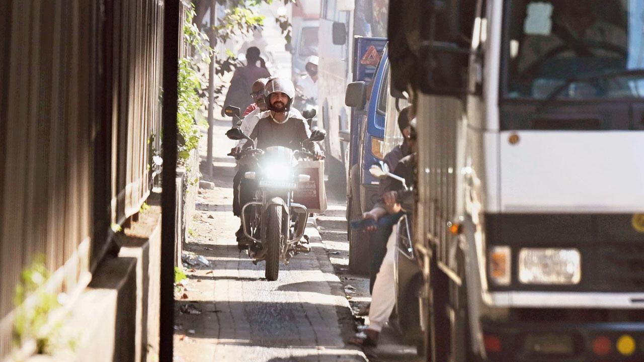 Motorcyclists ride along a footpath meant for pedestrians, highlighting the very problems the BMC’s ‘Pedestrian First’ campaign aims to address. File pics/Ashish Raje
