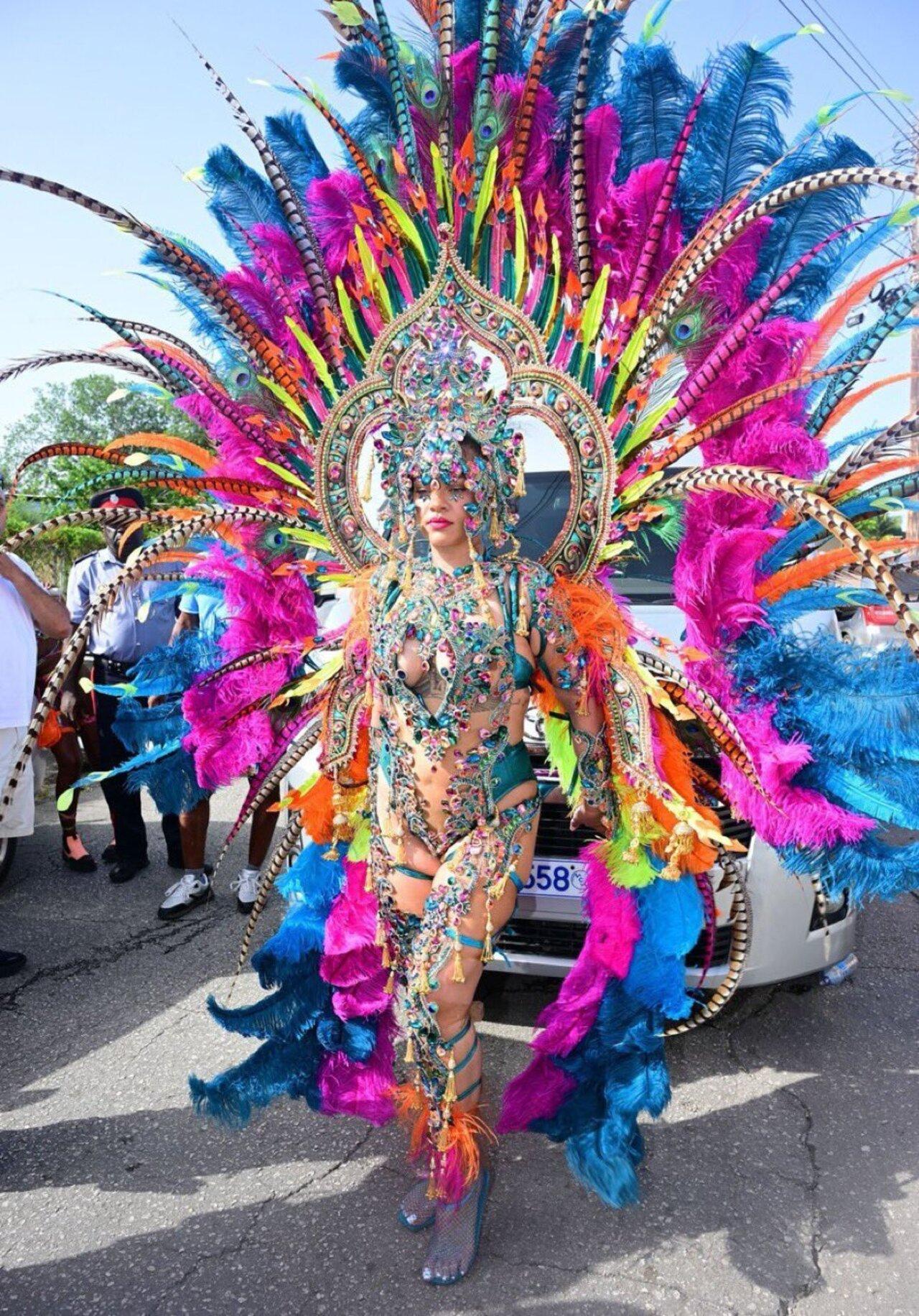 2026
Rihanna made a grand return in 2026 in a bodysuit featuring intricate multi-colored sapphire, emerald, and hot pink gemstones arranged to mimic cascades of body jewellery. The ensemble further featured a towering, seven-pronged headpiece and a massive floor-length feathered bustle in vivid turquoise, orange, and pink.