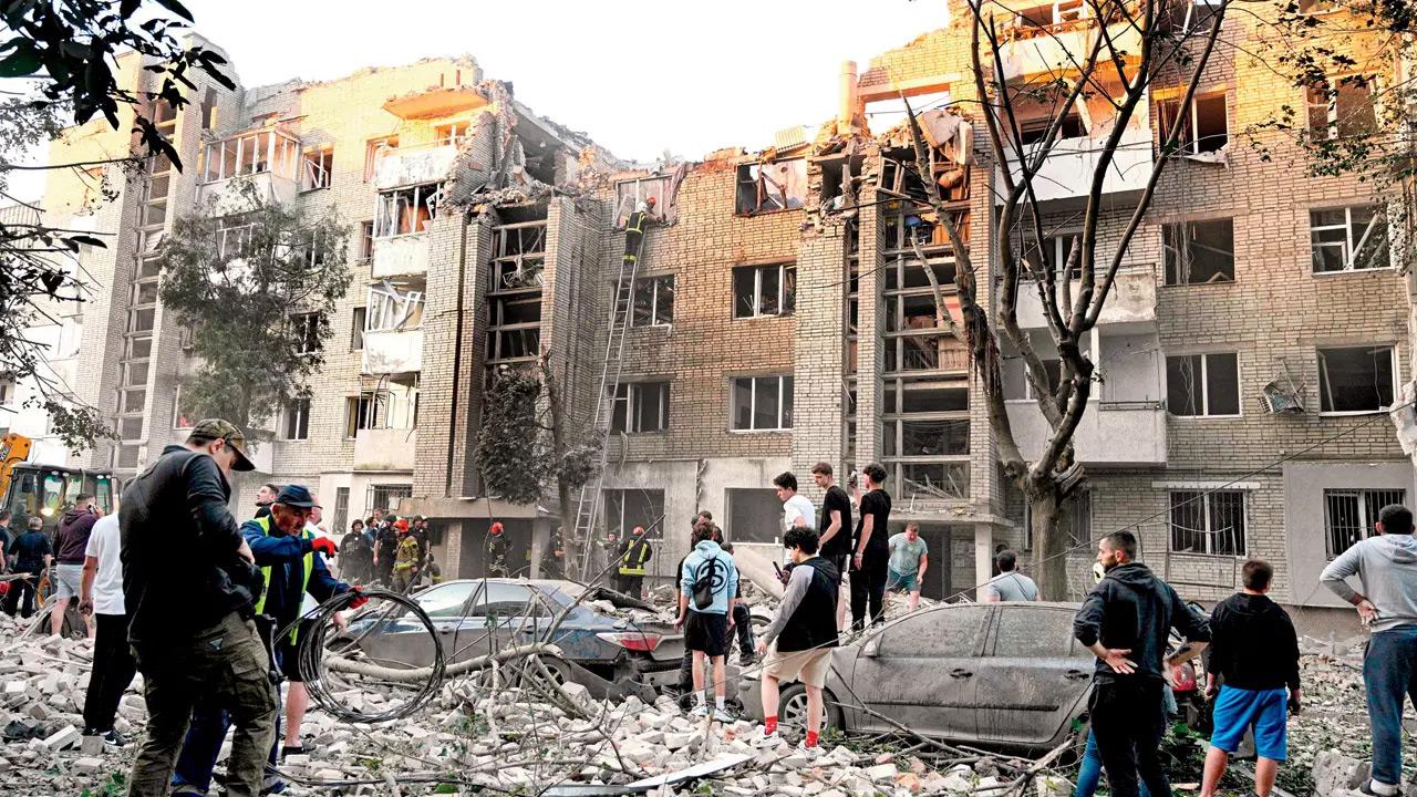 Three killed, over a dozen injured in Russian missile and drone attack on Kyiv Local residents watch first responders operate at a building destroyed by Russian strikes in the Ukrainian city of Lviv, on Thursday. PIC/AFP