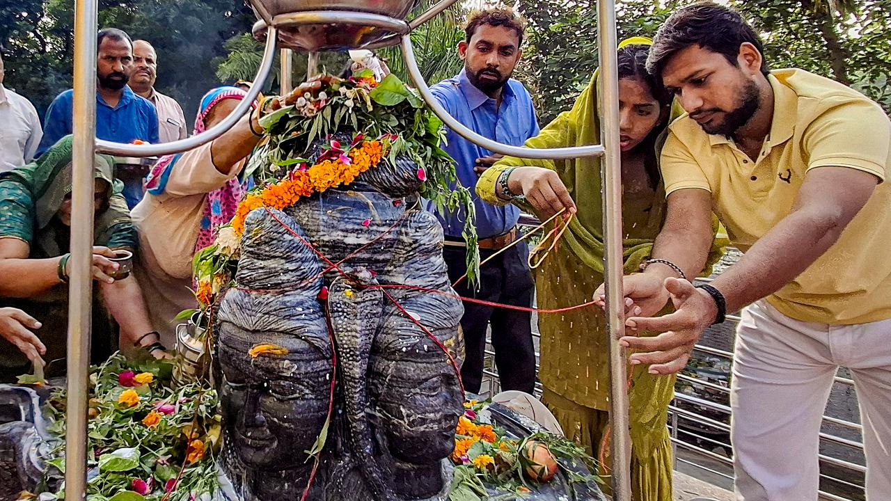 People offer prayers on the second 'Monday' of the holy month of 'Shravan', at Sector 10, in Gurugram, Monday, August 10