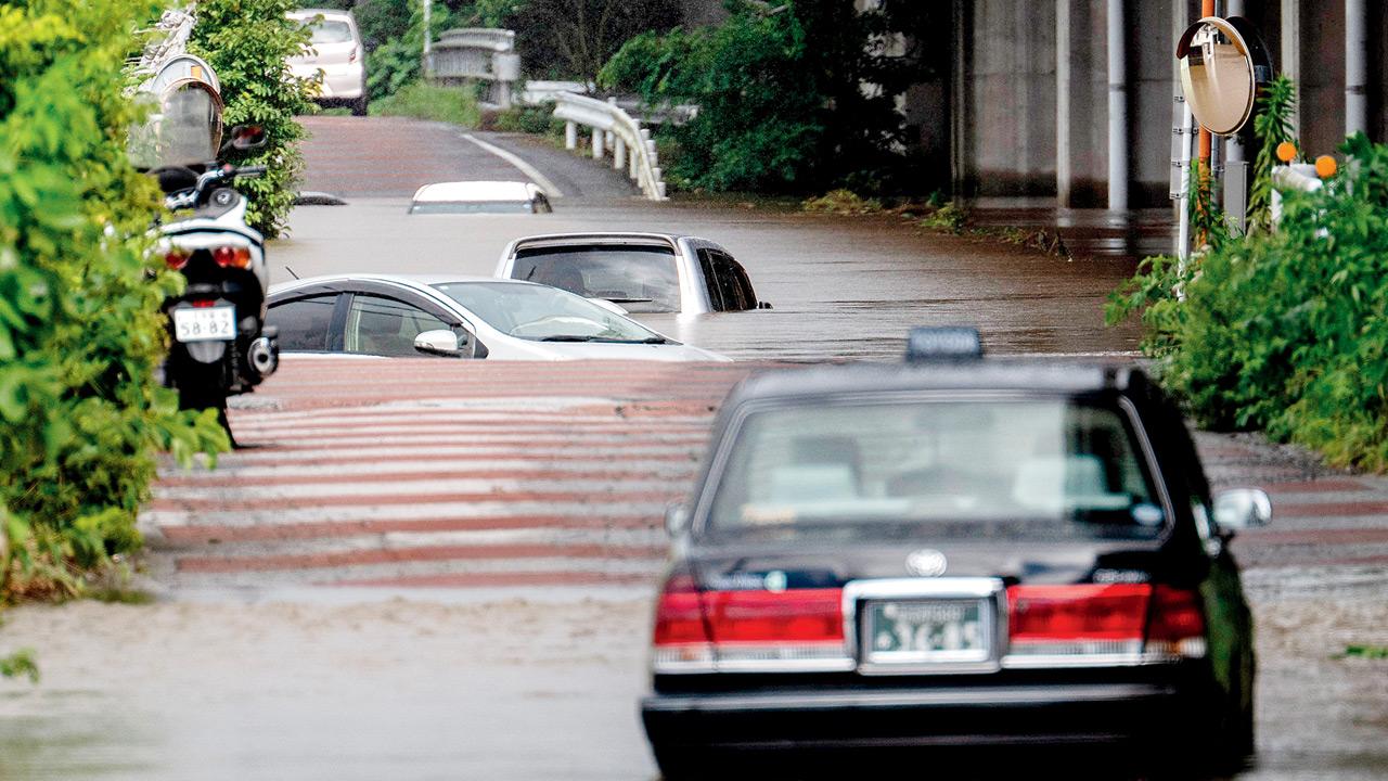 Record rainfall near Tokyo kills five, leaves one missing as floods strand thousands Abandoned cars seen partially submerged on a flooded road in Sakura, Chiba prefecture. PICS/AFP