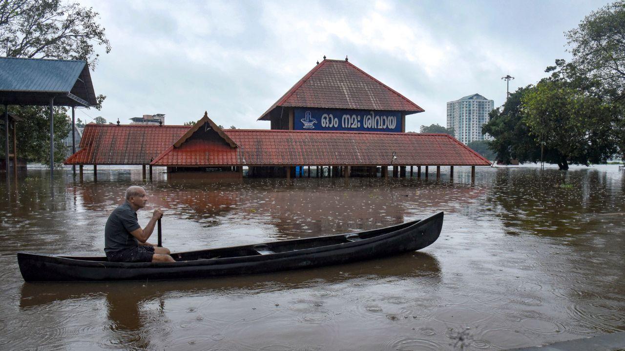 A man paddles a canoe past the inundated Sree Mahadeva Temple in a waterlogged area following heavy rain, in Kochi, Kerala, Saturday (PICS/PTI)
