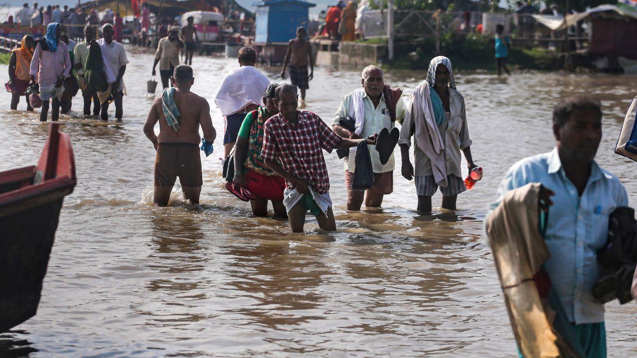 People wade through a waterlogged road along the banks of the swollen Ganga following heavy rainfall in Prayagraj, Uttar Pradesh, on Wednesday, August 19, 2026
People wade through a waterlogged road along the banks of the swollen Ganga following heavy rainfall in Prayagraj, Uttar Pradesh, on Wednesday, August 19, 2026
