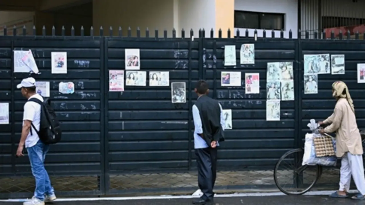 IN PHOTOS: Nepal floods families brave damaged roads to check on cutoff villages Family members look at posters displaying details of people who died in the devastating floods outside a hospital mortuary in Kathmandu.