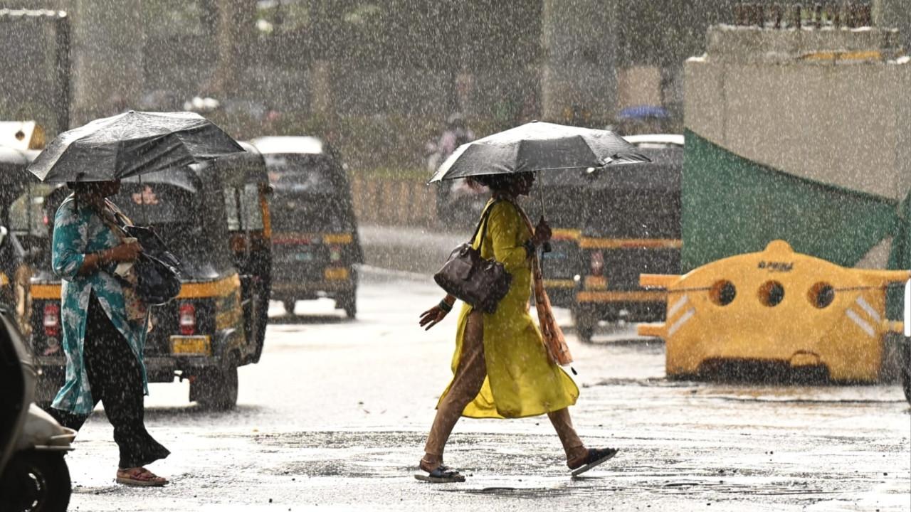 IN PHOTOS: Commuters make their way through as rains lash parts of Mumbai The downpour added to the challenges faced by pedestrians travelling through the area. Pics/Satej Shinde