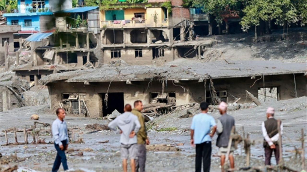 Local residents inspect houses lying deluged in sludge after flash floods at Devighat, Bidur Municipality in Nepal's Nuwakot district. Pic/AFP