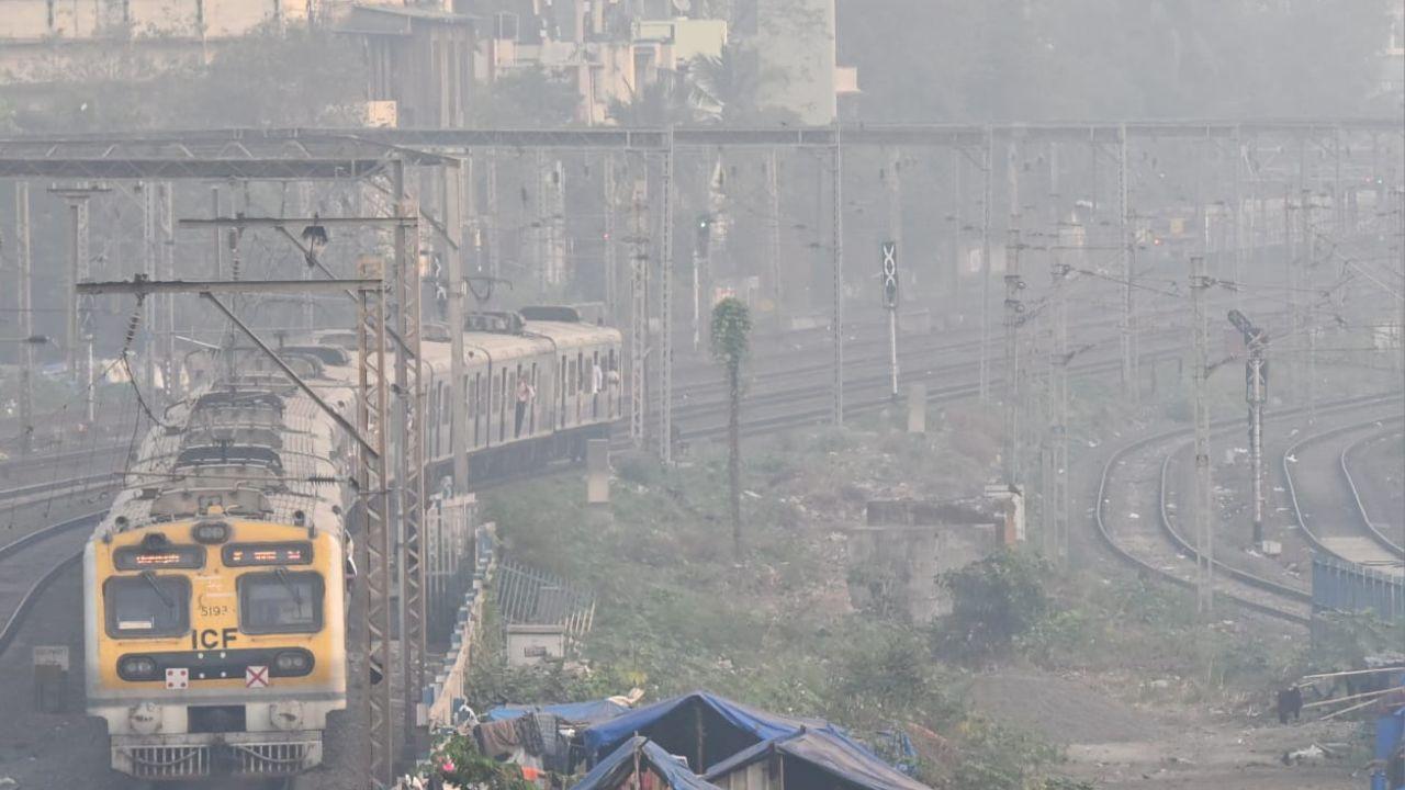 Haze is seen from the footbridge of Khar railway station against the city skyline in Khar, Mumbai