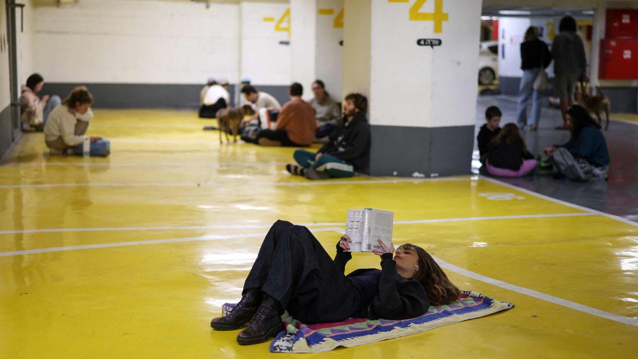 Families and residents take refuge in a parking garage in Tel Aviv after Israeli and U.S. strikes on Iranian military sites prompted warnings of potential retaliation