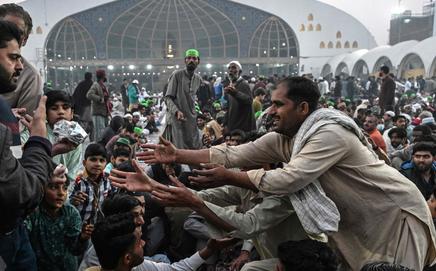 Devotees receive free iftar meals on Day 1 of Ramadan at Data Darbar shrine in Lahore on Thursday. PIC/AFP