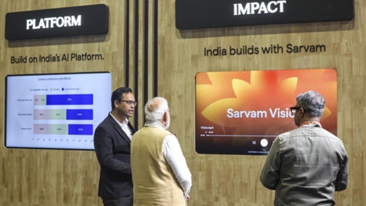 The Prime Minister tries a sleek, spectacles-like AI device, symbolising the futuristic technology on display at the summit