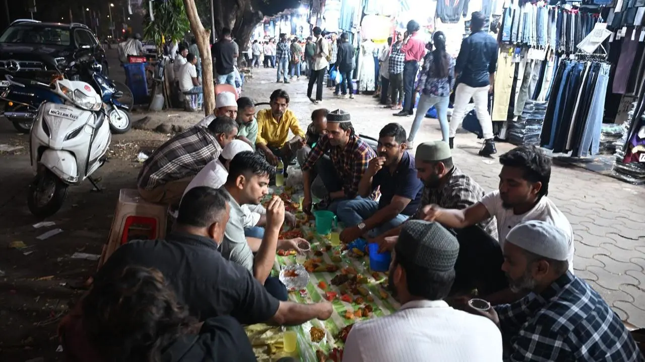 As the sun sets on the first day of Ramadan, devotees gather near Fashion Street in Mumbai's Churchgate area to break their fast