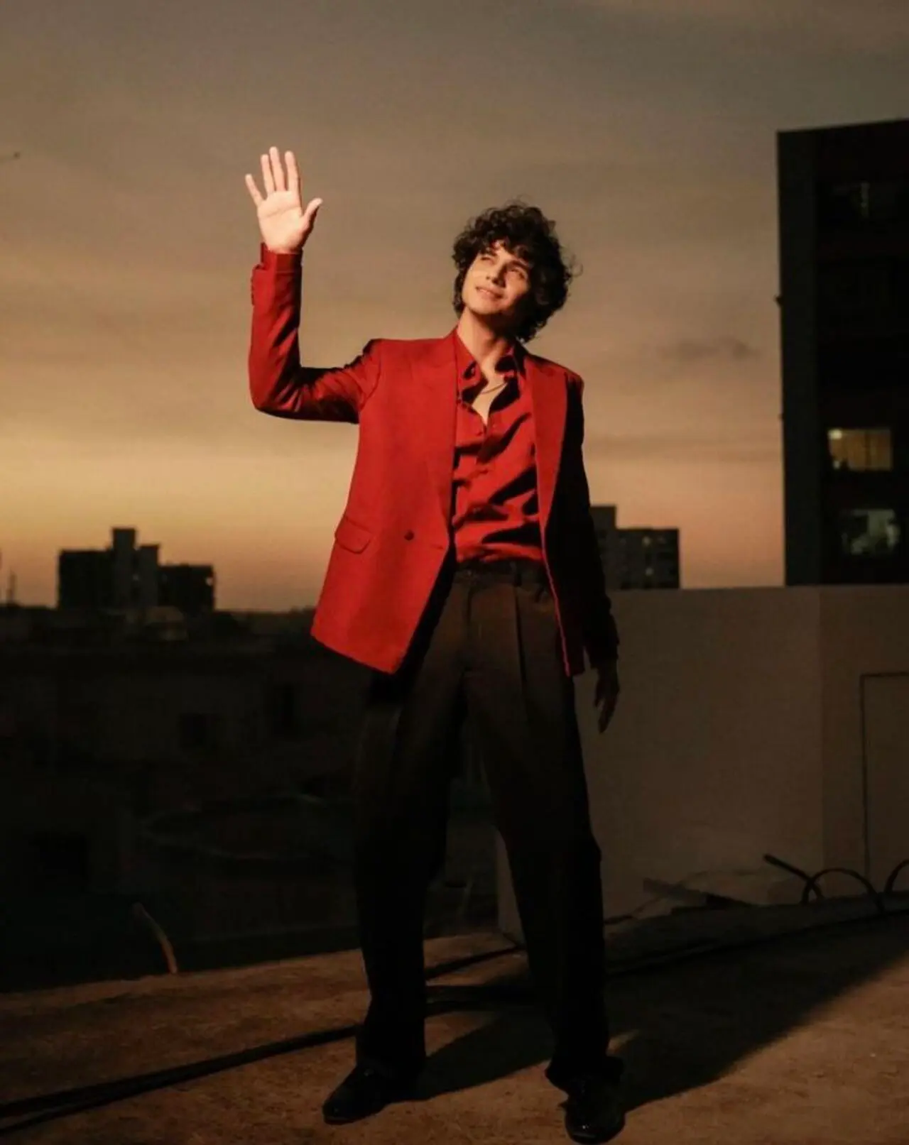 Abhay Verma paints the town red in his red blazer over a red button-down silk or satin shirt, paired with black trousers, for a sophisticated V-Day outfit.