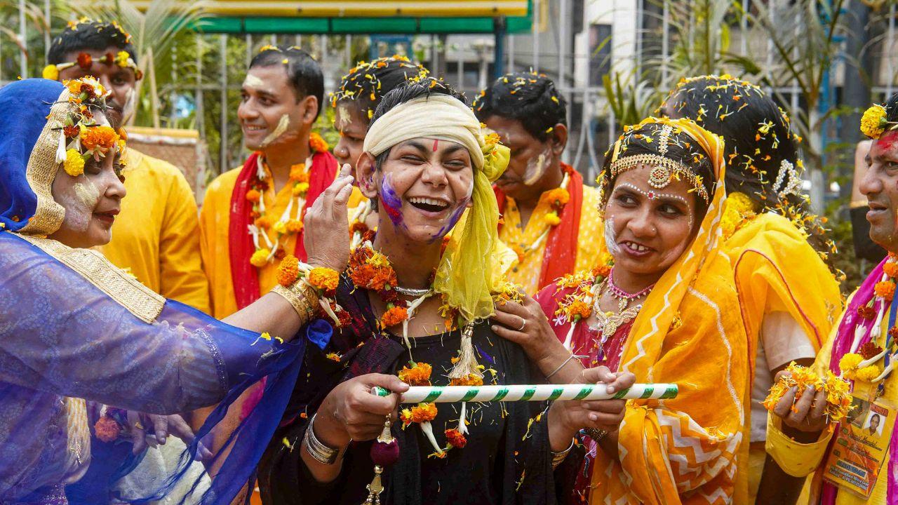 In Kolkata, visually impaired children toss flower petals during a cultural programme, underscoring the inclusive spirit of the festival that celebrates the triumph of good over evil