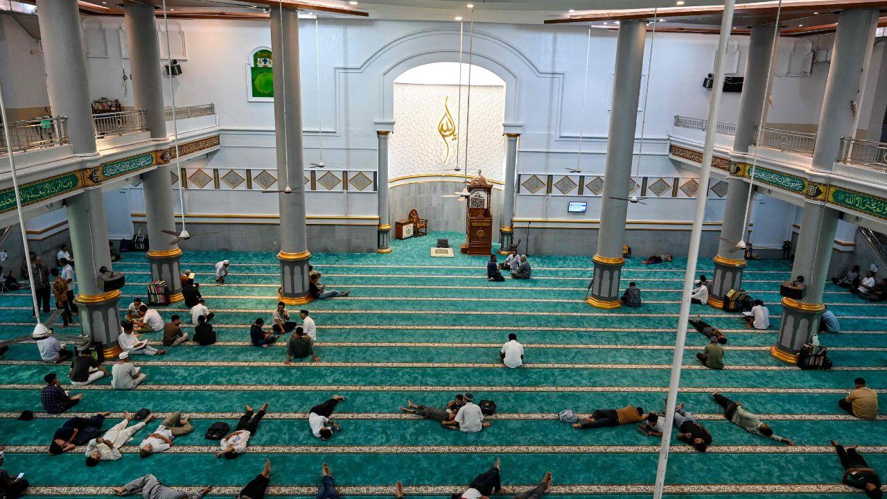 Some men rest while others read the Koran following congregational noon prayers at Banda Aceh