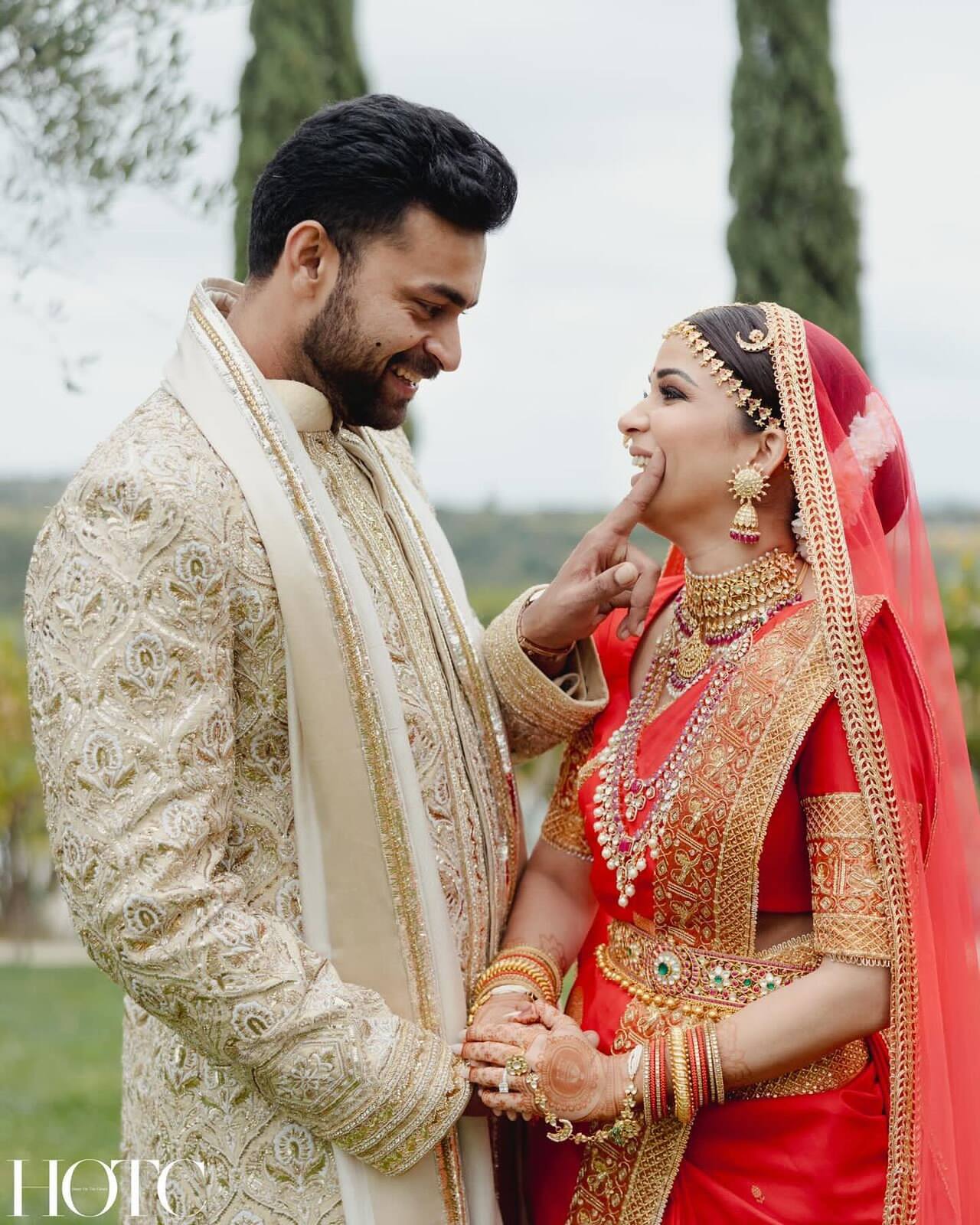 Lavanya chose a red bridal outfit. She had her hair covered in a net dupatta and paired her wedding look with gold jewellery, which comprised necklaces, bangles, haath phool, matha patti and matching hair accessories.