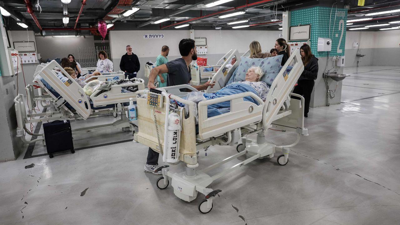 Medical teams move patients to a protected parking structure at Sourasky Medical Center after hospitals activate emergency protocols in anticipation of possible missile impacts