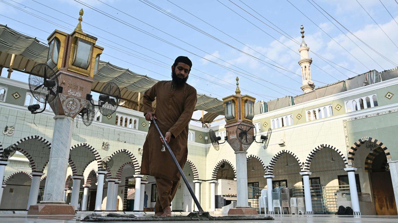 A worker cleans the floor of a mosque in Karachi, symbolising spiritual and physical purification ahead of a month devoted to prayer, reflection, and self-restraint