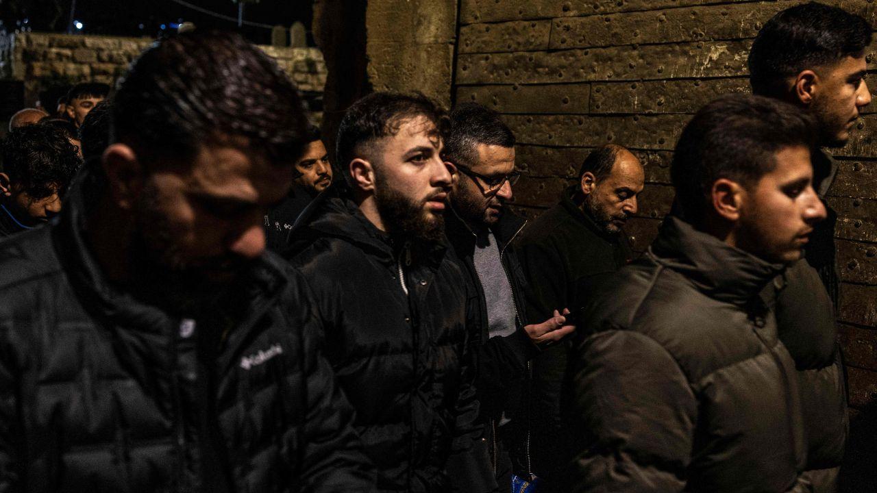 Worshippers walk through Lions Gate at the end of the first day, reflecting the blend of spirituality and city life.