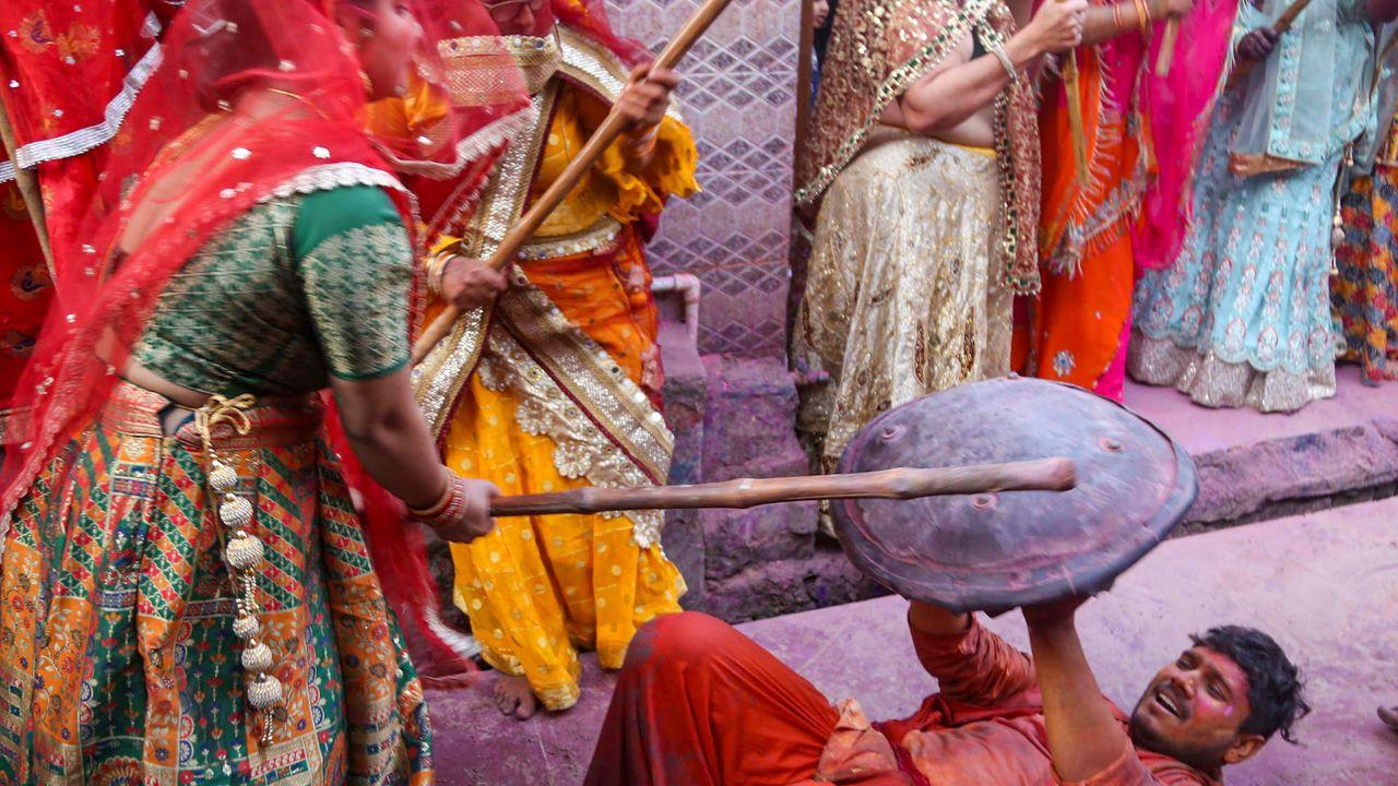 <p>Men shield themselves as women playfully strike with decorated sticks during the iconic Lathmar Holi at Banaras, Mathura</p> <p>Men shield themselves as women playfully strike with decorated sticks during the iconic Lathmar Holi at Banaras, Mathura</p>