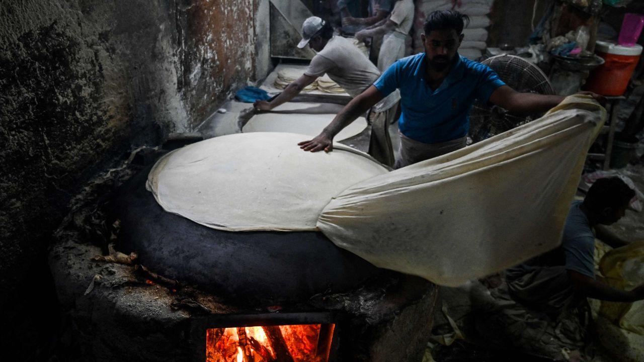 Bakers prepare fresh bread at a neighborhood snack shop in Karachi on the eve of Ramadan, readying kitchens for pre-dawn 'Suhur' and evening Iftar meals