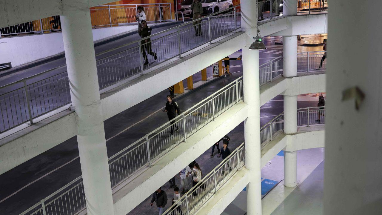 People gather in an underground garage in Tel Aviv as air raid sirens warn of possible Iranian retaliatory strikes
