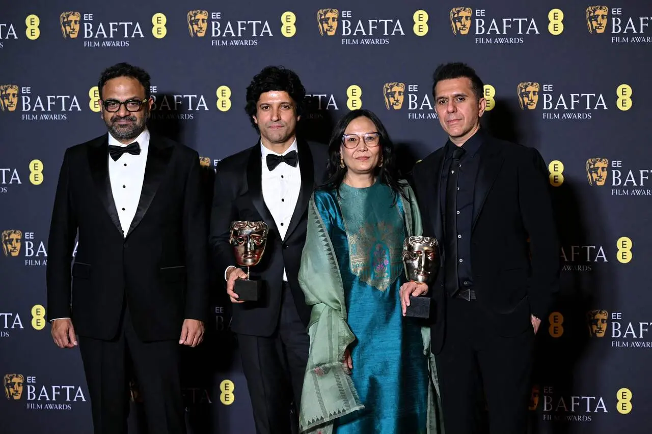 Farhan Akhtar-backed Boong won in Best Children’s & Family Film category. The actor posed with film's crew at red carpet. He made simple yet sharp appearance in a classic black tuxedo with satin lapels and a bow tie.