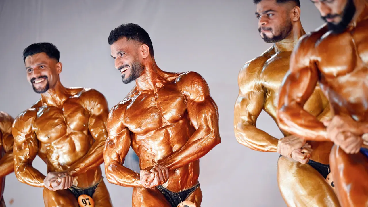 Smiles met symmetry as male bodybuilders grinned through their poses, owning the stage with confidence and charisma