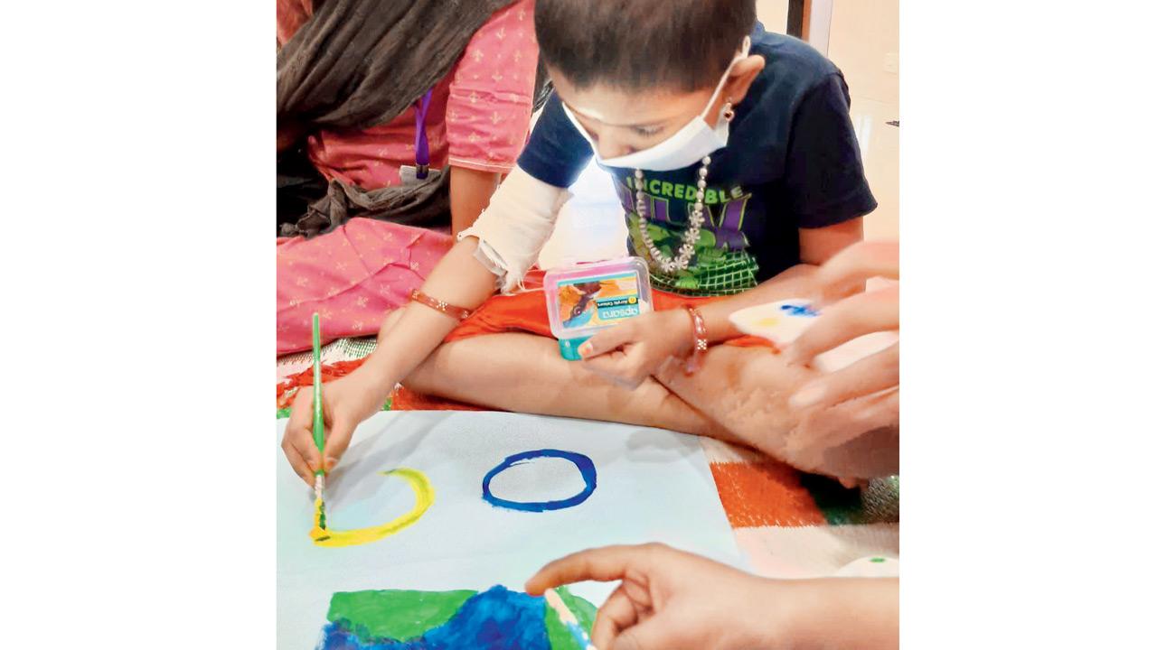 A child paints on a canvas. Pic courtesy/Access Life