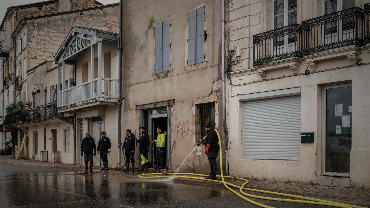 Firefighters and locals clean mud from streets in La Réole. France's record 40-day rainy streak ended on Monday, but flooding persists despite gradual improvement, says Météo-France, the country's weather bureau