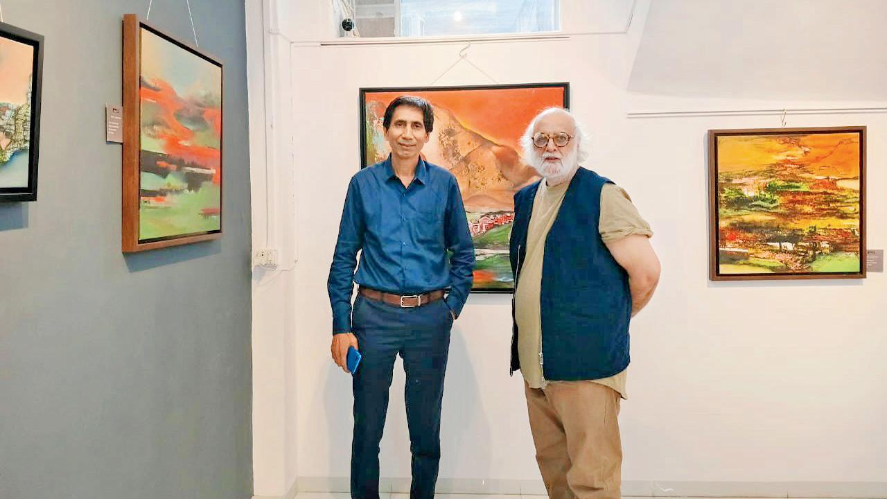 (From left) Sunil Chauhan gives Gurcharan Singh a walkthrough at the Kala Ghoda gallery. PIC COURTESY/SUAN ARTLAND GALLERY