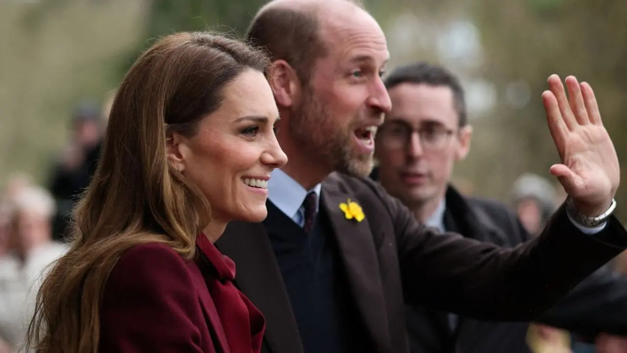 Rain-soaked royal charm: Kate Middleton and Prince William greet crowds in Wales