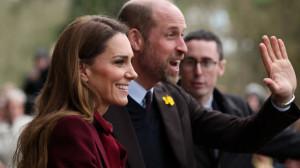 Rain-soaked royal charm: Kate Middleton and Prince William greet crowds in Wales