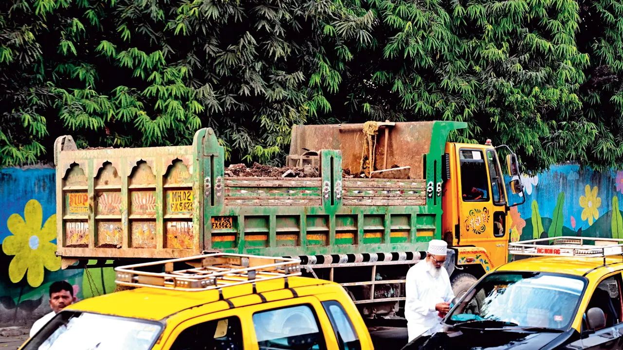 A truck carrying construction debris without a cover on the service road near Kherwadi Junction in Bandra East. File pic/SATEJ SHINDE