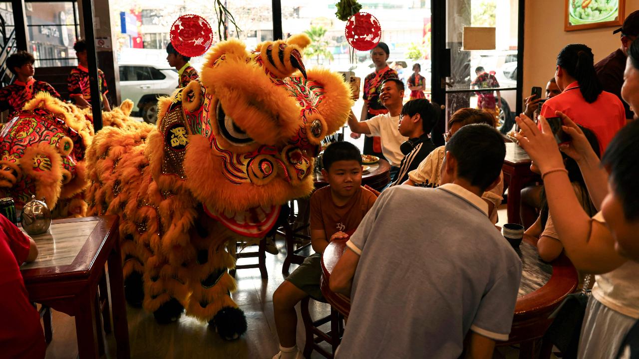 Traditional Chinese lion dance performers entertain diners inside a restaurant during Lunar New Year celebrations marking the beginning of the Year of the Horse, in Panama City on February 17