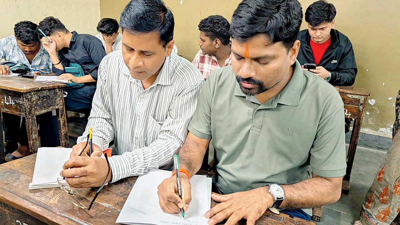 Rajesh Sawant, 41, (right) prepares for his Std XII board exams through a night school. Pics/Aditi Arulkar
