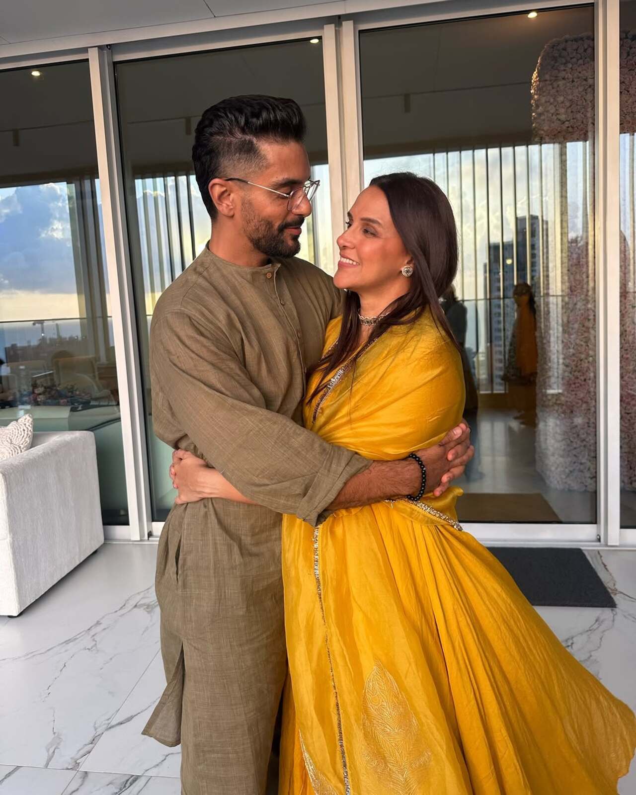 <p>Amid festive celebrations, Angad Bedi and Neha Dhupia share a loving gaze that speaks volumes. Their warmth and affection light up every frame.</p>