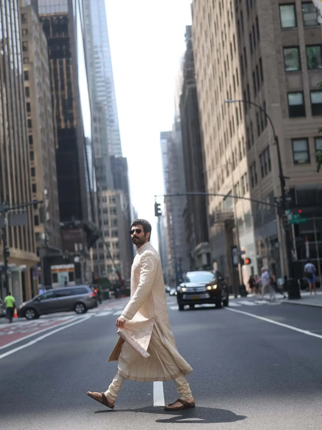 Finishing the look with contemporary sunglasses and sandals is the quintessential 